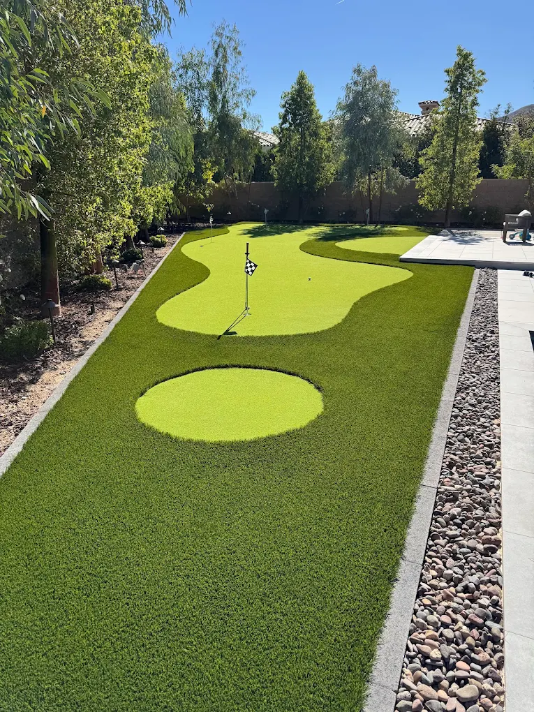 Artificial turf putting green with decorative rock landscaping in Las Vegas