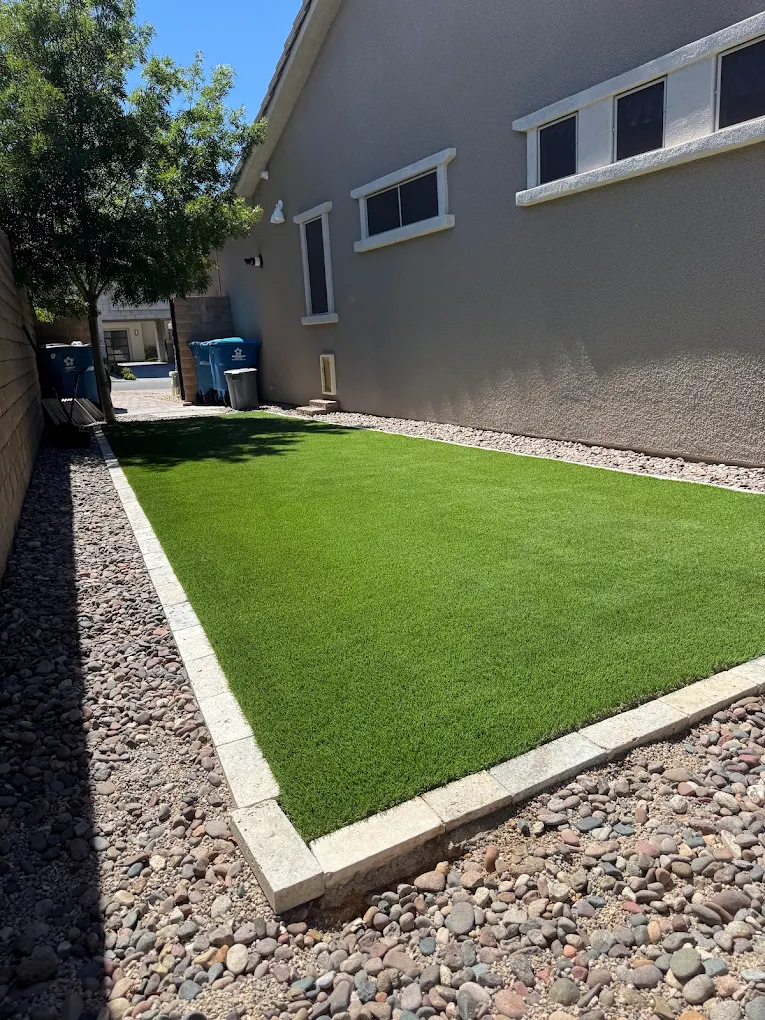 Side yard with clean artificial turf in a Las Vegas home